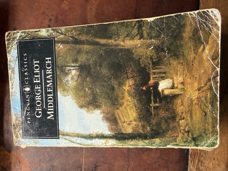 Robbie's copy of Middlemarch by George Eliot, a Penguin Classics paperback. The cover shows a nineteenth-century landscape painting of a country path beside trees, with a small figure walking along it.